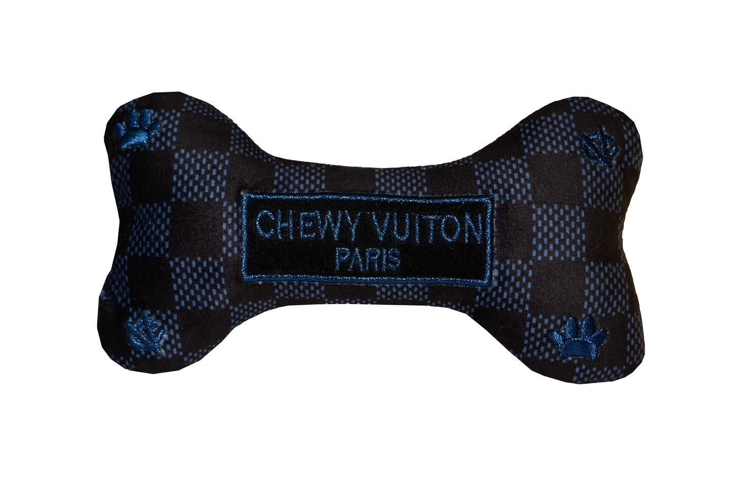 Plush dog bone toy in black and blue check pattern with blue embroidered icons and a “Chewy Vutton Paris” label. Luxury designer-style squeaky chew toy for pets.