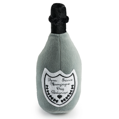 Plush dog toy shaped like a champagne bottle in grey and black with an embroidered label reading “Dog Perignon”. Soft squeaky novelty chew toy for pets.