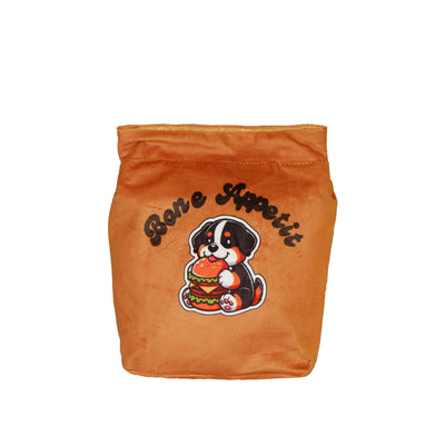 Plush dog lunch box bag in brown with “Bone Appetit” text and a cute cartoon puppy holding a burger. Soft toy storage bag for pets.