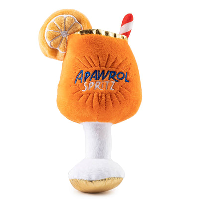 Plush dog toy shaped like an Apawrol Spritz cocktail glass with an orange slice and straw, featuring embroidered details. Soft squeaky novelty chew toy for pets.