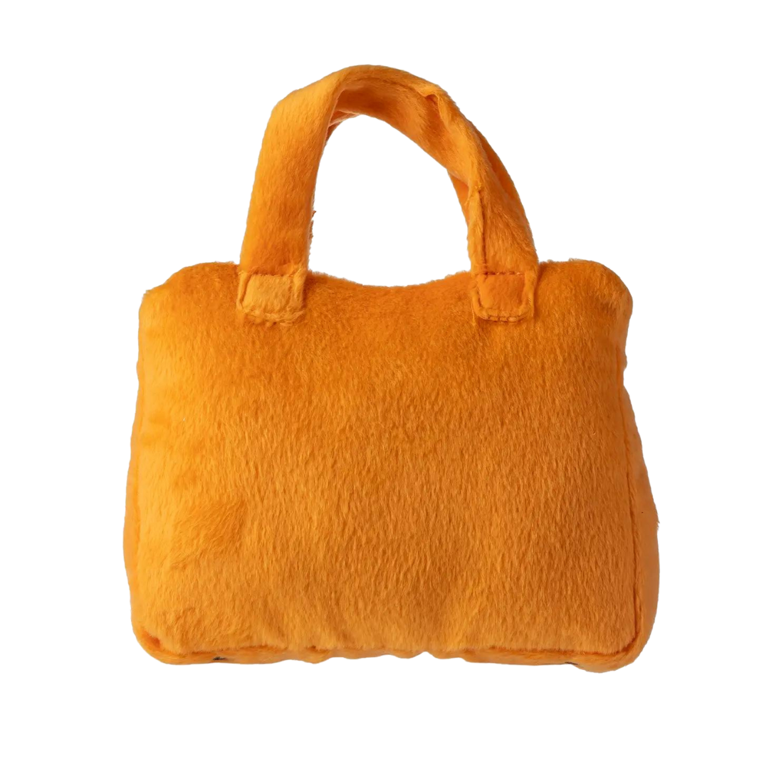 Plush dog toy shaped like a handbag with soft handles and embroidered text “Rich Bitch” on the front. Available in pink and orange colors. Luxury squeaky chew toy for pets.