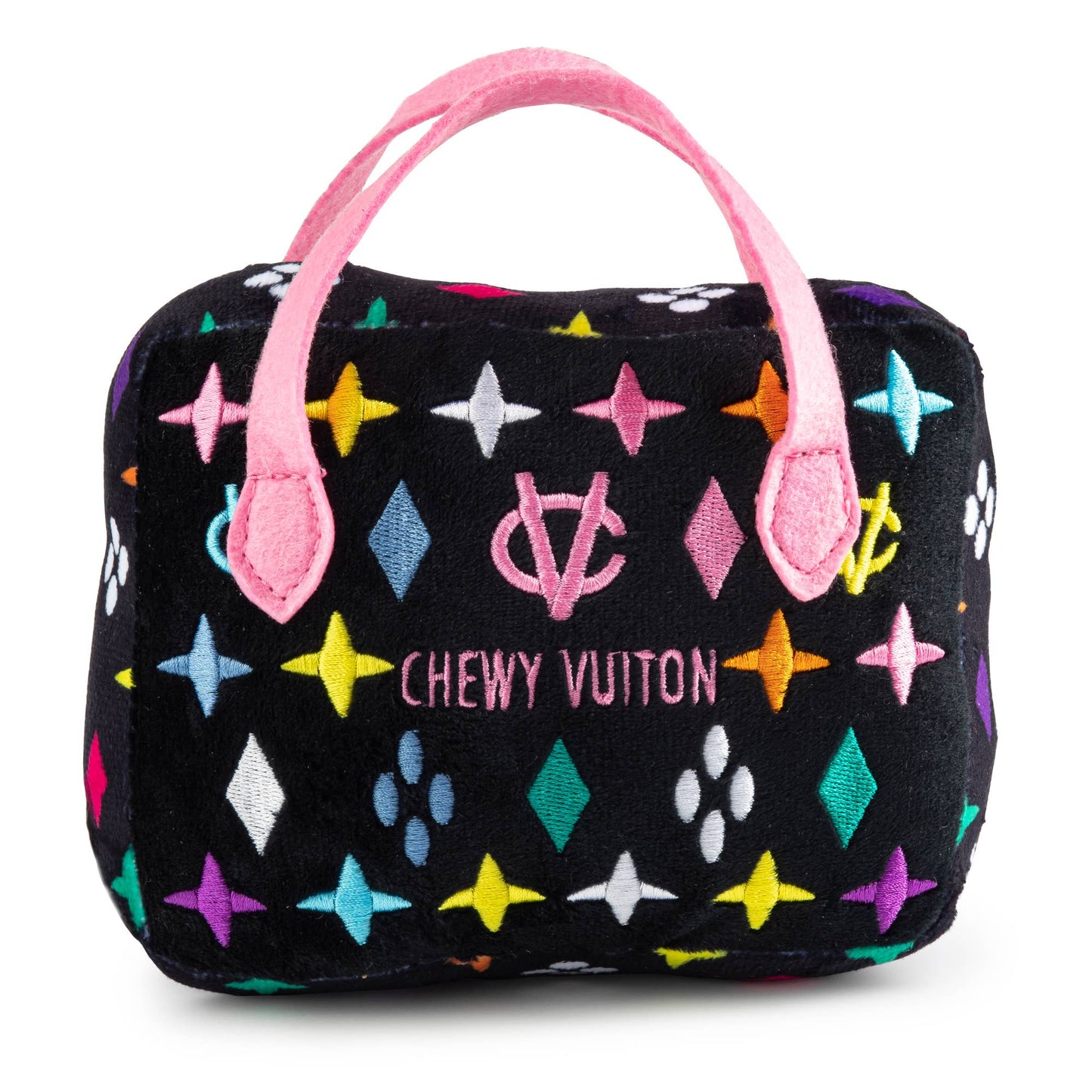 Plush dog toy shaped like a designer handbag with a black base, colorful embroidered icons, and pink handles featuring a “Chewy Vuiton Paris” label. Luxury squeaky chew toy for pets.