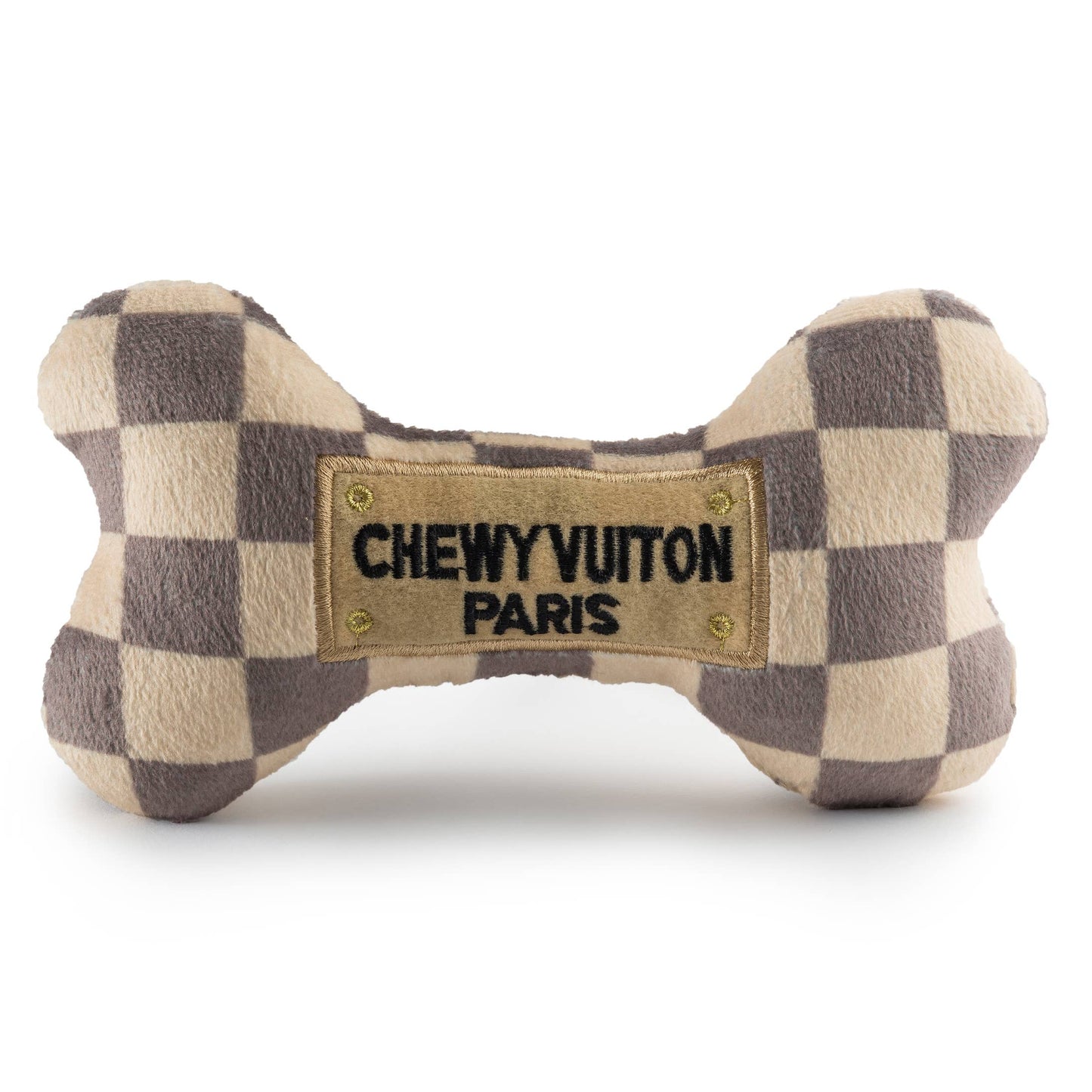 Plush dog bone toy with beige and brown check pattern and a stitched “Chewy Vuiton Paris” label. Soft luxury squeaky chew toy for pets.