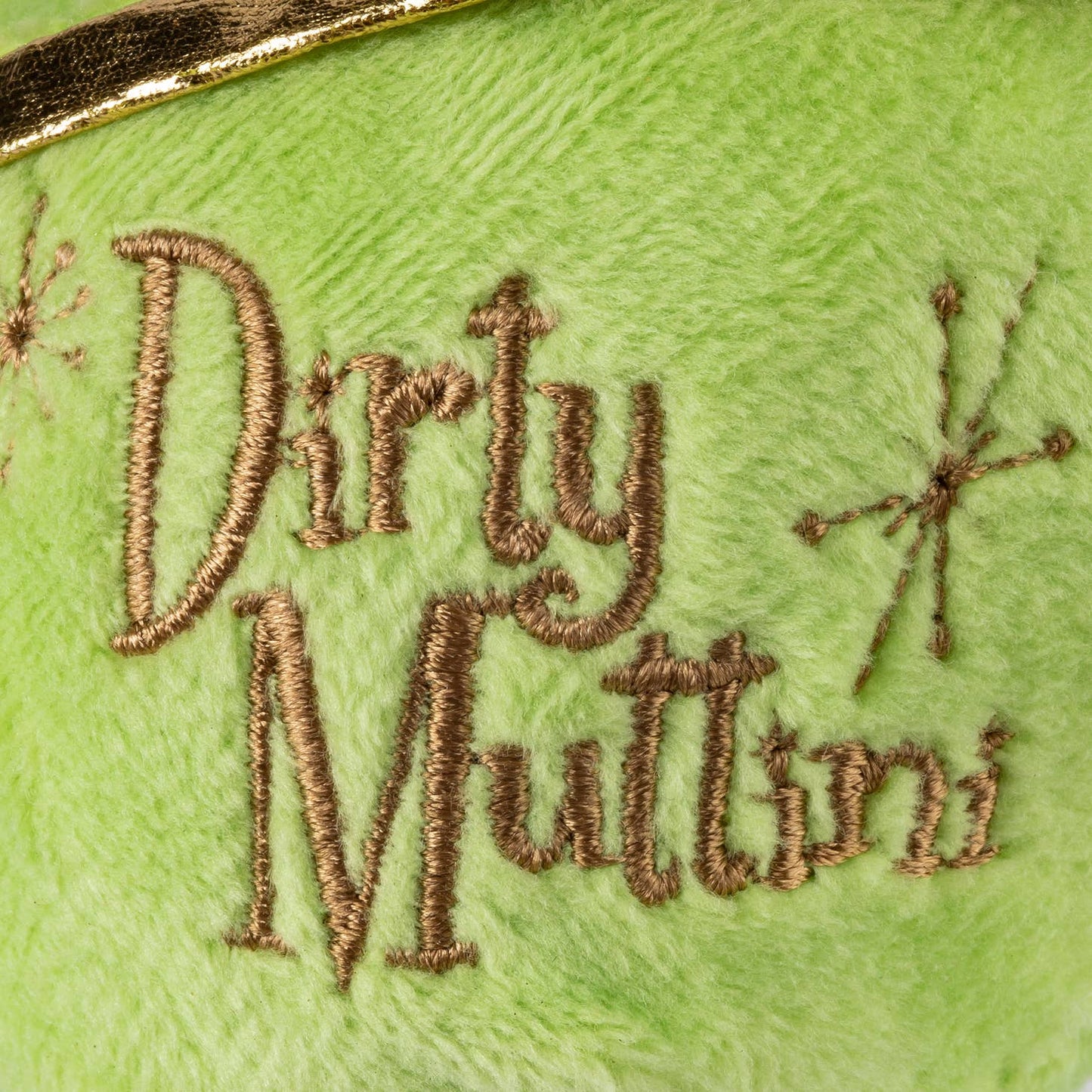 Plush dog toy shaped like a martini glass with a green olive on top, gold trim, and the embroidered words "Dirty Muttini." White stem and gold base, soft squeaky chew toy for pets.