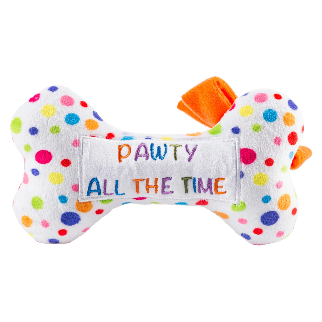 White plush dog bone toy with colorful polka dots, an orange bow, and embroidered “Happy Birthday” text. Soft squeaky celebration chew toy for pets.
