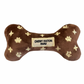 Plush brown dog bone toy with gold embroidered icons and a “Chewy Vutton Paris” label. Soft luxury squeaky chew toy for pets.