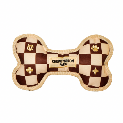 Luxury plush dog bone toy with brown check pattern and embroidered “Chewy Vutton Paris” label. Soft squeaky designer-style chew toy for pets.