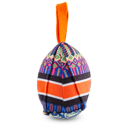 Plush dog toy shaped like a handbag with colorful geometric pattern, orange handles, and “Dogior” embroidered on the front. Soft designer-style squeaky chew toy for pets.