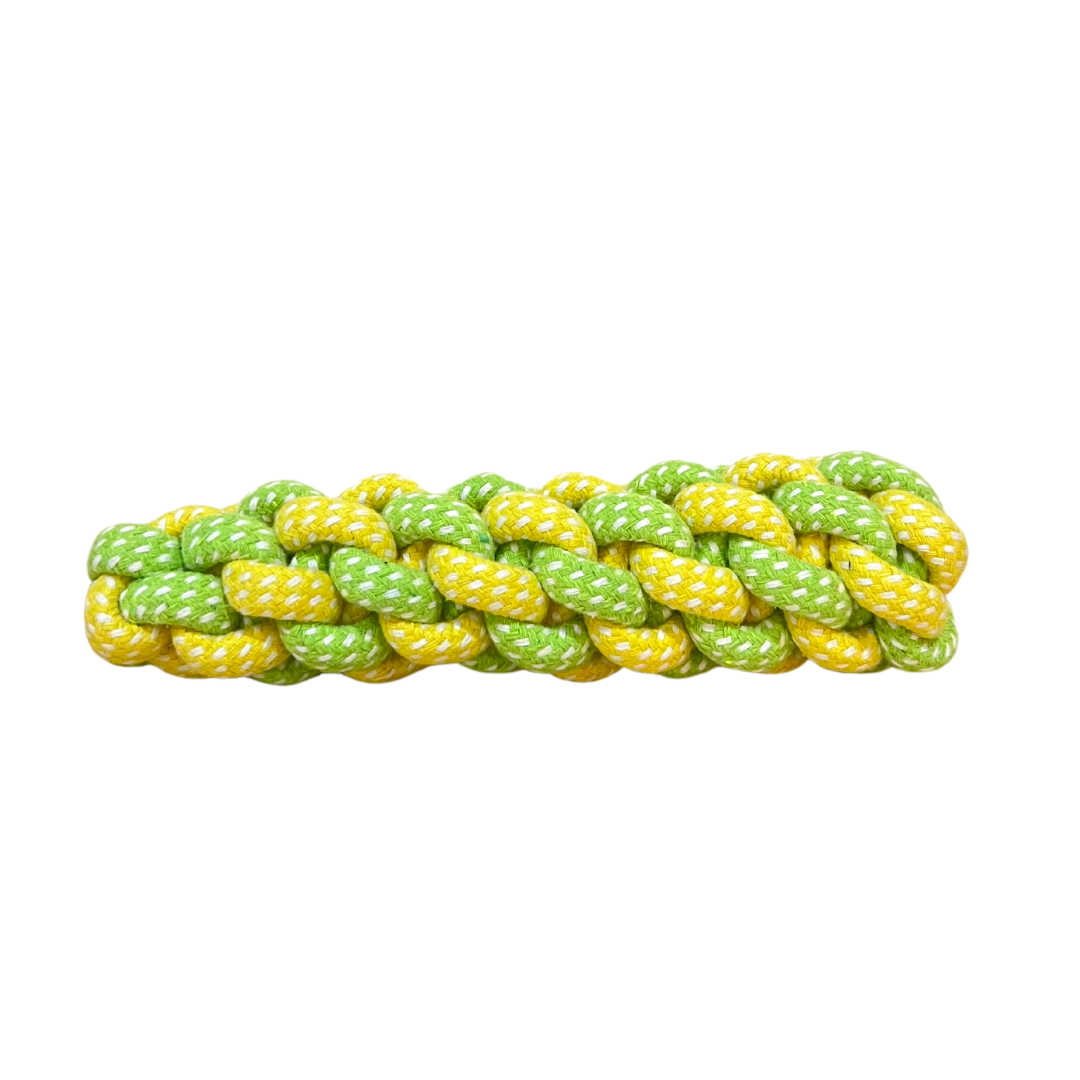 Braided rope dog chew toy in green and yellow. Durable woven tug and chew toy for pets.