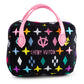 Plush dog toy shaped like a designer handbag with a black base, colorful embroidered icons, and pink handles featuring a “Chewy Vuiton Paris” label. Luxury squeaky chew toy for pets.