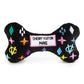 Black plush dog bone toy with colorful embroidered designer-style icons and a “Chewy Vuiton Paris” label. Soft luxury squeaky chew toy for pets.