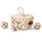 Plush interactive dog toy shaped like a designer-style trunk with a beige and lavender check pattern, rope handle, and “Chewy Vuiton Paris” label, including four matching plush balls to hide and retrieve.