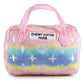 Plush dog toy shaped like a designer handbag with pink handles and a pastel rainbow gradient featuring embroidered icons and a “Chewy Vuiton Paris” label. Soft luxury squeaky chew toy for pets.