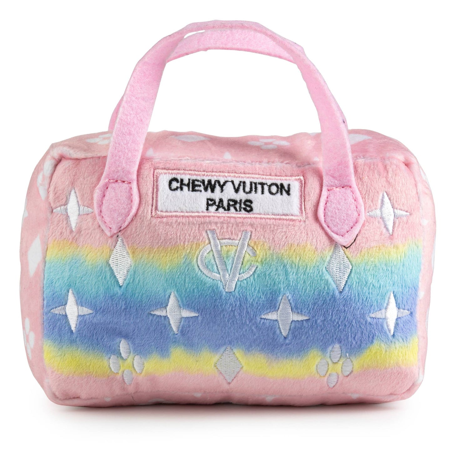 Plush dog toy shaped like a designer handbag with pink handles and a pastel rainbow gradient featuring embroidered icons and a “Chewy Vuiton Paris” label. Soft luxury squeaky chew toy for pets.