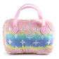 Plush dog toy shaped like a designer handbag with pink handles and a pastel rainbow gradient featuring embroidered icons and a “Chewy Vuiton Paris” label. Soft luxury squeaky chew toy for pets.