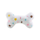 Luxury-inspired white Chewy Vuiton plush dog bone toy with pastel embroidered designer motifs for dogs.