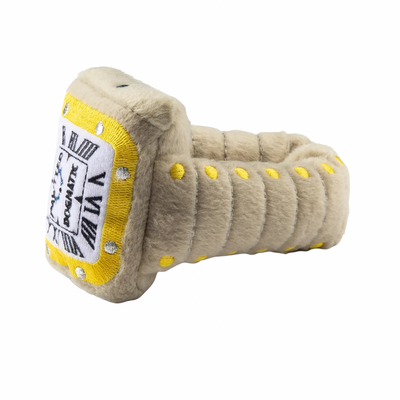 Plush dog toy shaped like a luxury wristwatch with a beige strap, yellow accents, and embroidered watch face details. Soft squeaky designer-style chew toy for pets.