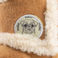 Plush dog toy shaped like a cozy winter boot with faux fur lining and an embroidered pug badge—cute chew toy for dogs.