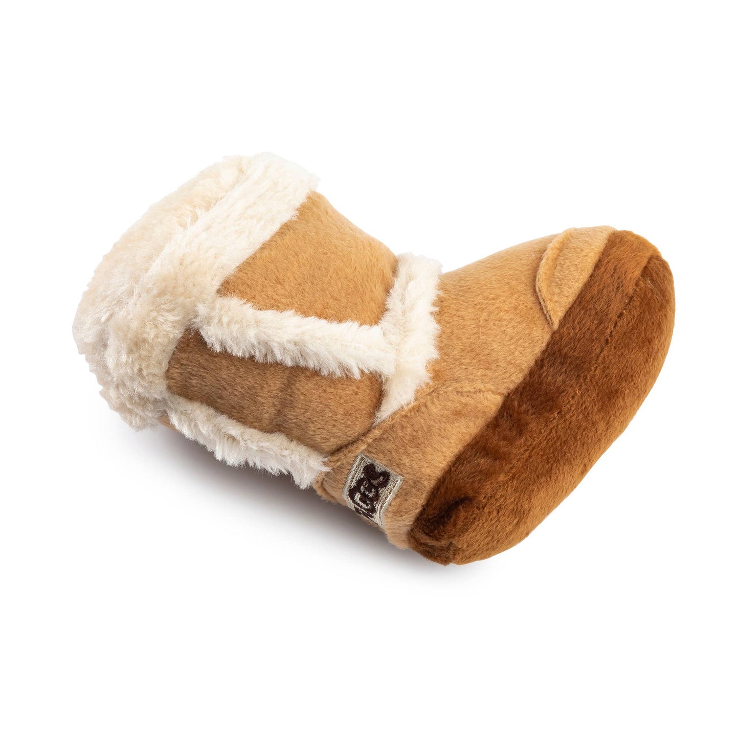 Plush dog toy shaped like a cozy winter boot with faux fur lining and an embroidered pug badge—cute chew toy for dogs.