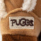 Plush dog toy shaped like a cozy winter boot with faux fur lining and an embroidered pug badge—cute chew toy for dogs.